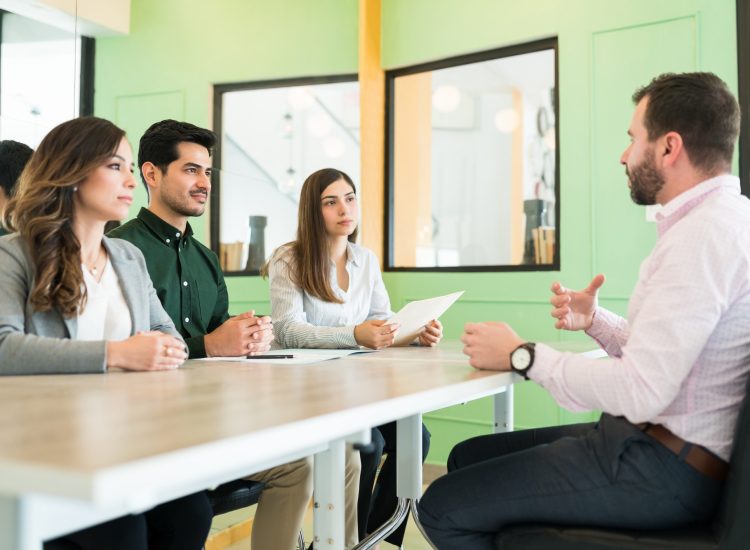 Applicant Discussing With Recruiters At Office